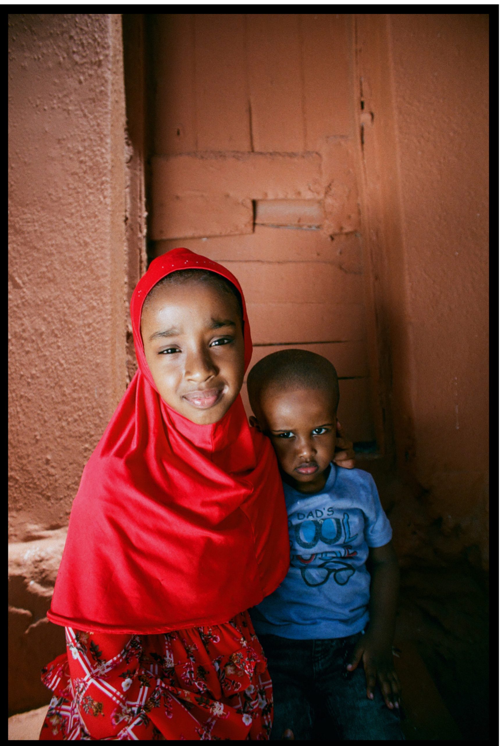 Heaven Lies At Thy Mothers Feet bu Faatimah Allie and Ya’eesh Dollie 3_Hijabi Daughter girl in red with younger brother in blue