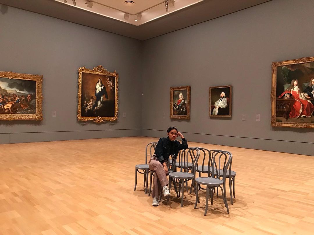 Posing in front of art